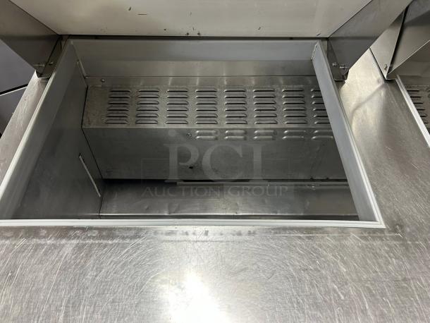 Continental SW60-24M sandwich prep table in great condition, 60" wide, 24 pans capacity, stainless steel interior, tested and working.