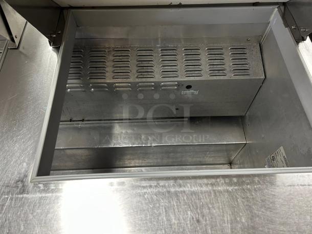 Continental SW60-24M sandwich prep table in great condition, 60" wide, 24 pans capacity, tested and working, interior view.