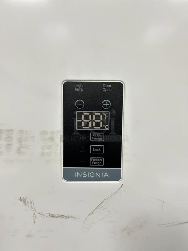Insignia 17 Cu. Ft. upright freezer control panel, white surface, with temperature display and mode buttons, garage-ready.