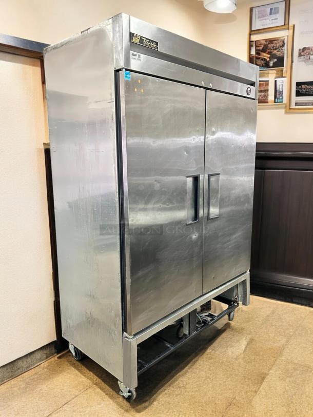 True T-49-HC 54" two-section stainless steel refrigerator, tested & working, on casters. Logo on upper left.
