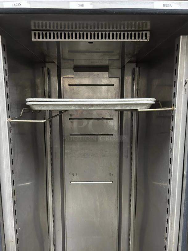 FWE UHST-13 mobile heated holding cabinet, 13 pan capacity, solid door, tested and working. Visible interior shelving.