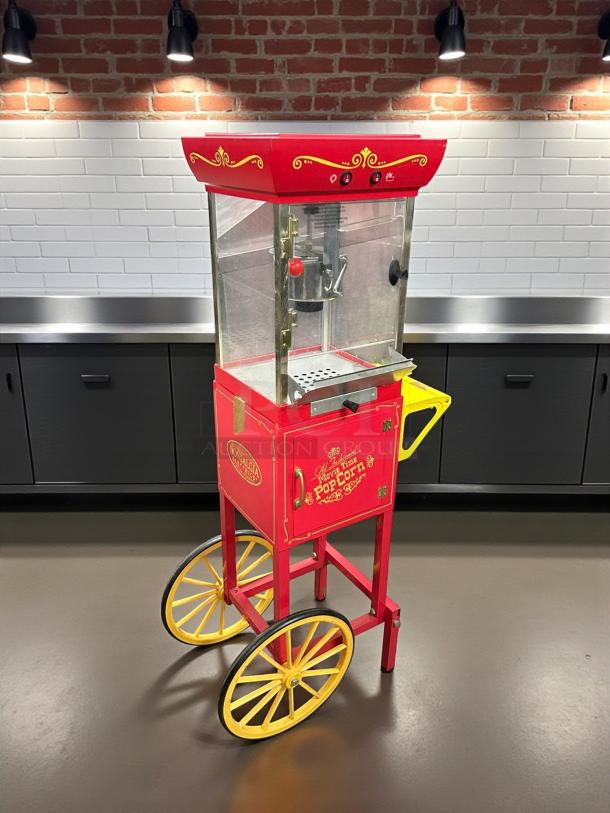 Nostalgia CCP-200 red popcorn machine cart in nice condition, tested, 0.25 cups oil capacity, freestanding with yellow wheels.
