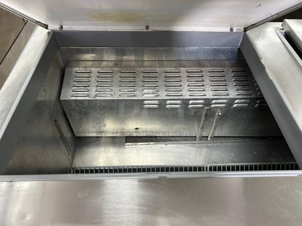 Continental Refrigerator SW72-N-18C sandwich prep table interior view. Stainless steel, great condition, usable storage space.