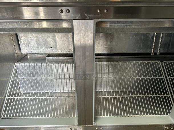 Continental Refrigerator SW72-N-18C sandwich prep table interior, showing clean wire shelving in great condition.