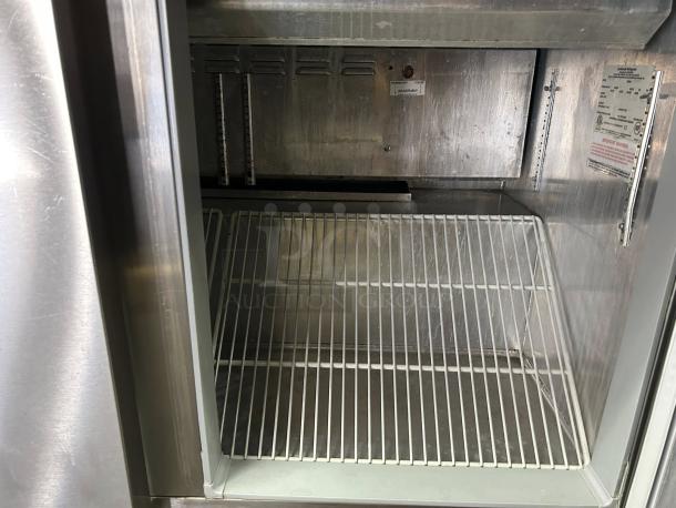 Continental Refrigerator SW72-N-18C sandwich prep table interior, shelved, clean, and in working condition, model label visible.