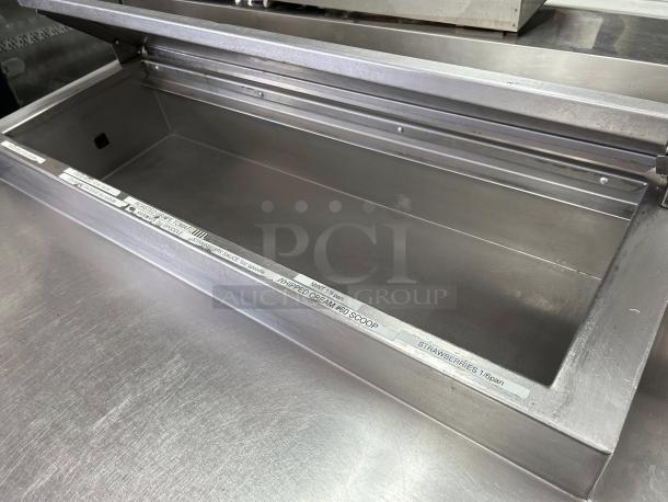 Delfield 000-20191PTC 3-door refrigerated pizza prep, stainless steel, 91in, tested, on casters, visible internal compartment.
