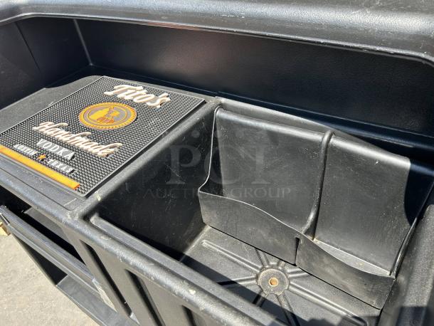 Cambro BAR540110 Cambar® 54" black portable bar in like new condition, featuring a 5-bottle speed rail and smooth rolling design.