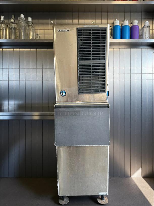 Hoshizaki ice machine, stainless steel, commercial grade, vertical design, moderate wear, visible cleaning instructions.