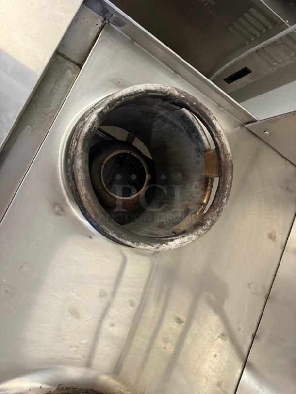 WESTAR C-2 Double Wok Burner Gas Range showing stainless steel surface and burner interior, tested and working condition.