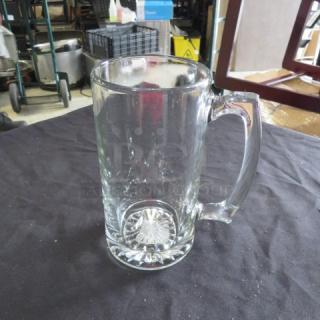 Clear 26.5oz beer mug with sturdy handle, excellent condition, features a starburst pattern on the base.