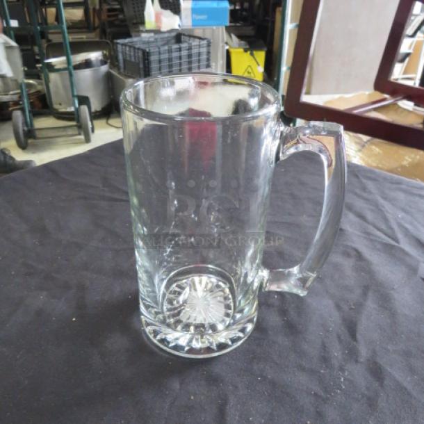 Clear glass beer mug, 26.5oz capacity, with sturdy handle and embossed star design on base. Excellent condition.