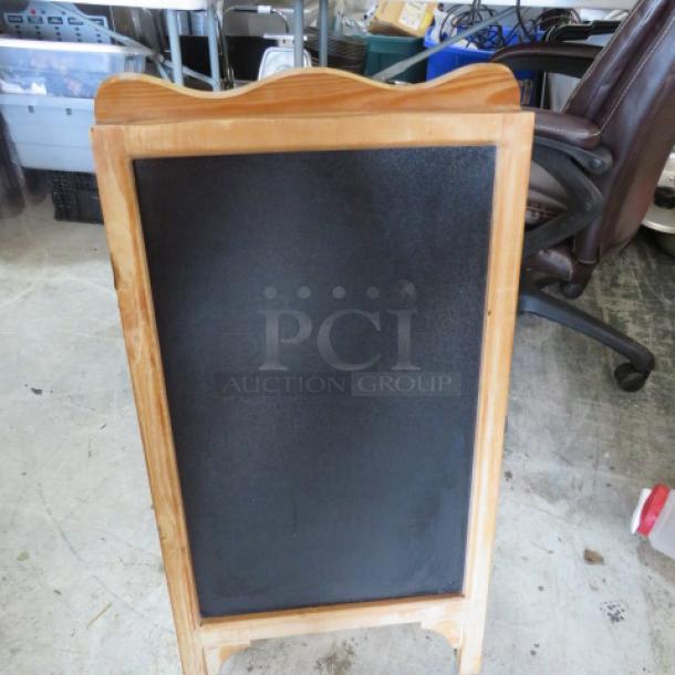 Wood-framed 16x32 sidewalk chalkboard sign, in good condition, suitable for outdoor use and business promotions.