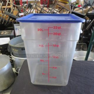 Clear 22-quart food storage container with blue lid and red measurement markings for volume tracking.