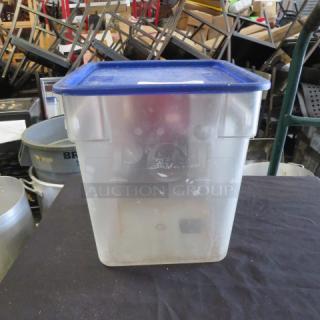 18-quart food storage container with blue lid, transparent body, minor wear, ideal for bulk storage.