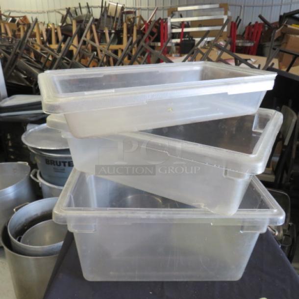 Clear plastic food storage containers, stackable, with lids; used condition; suitable for kitchen or restaurant use.