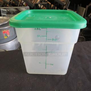 3.5 quart food storage container with green lid, marked with litre and quart measurements, item 4XBID.