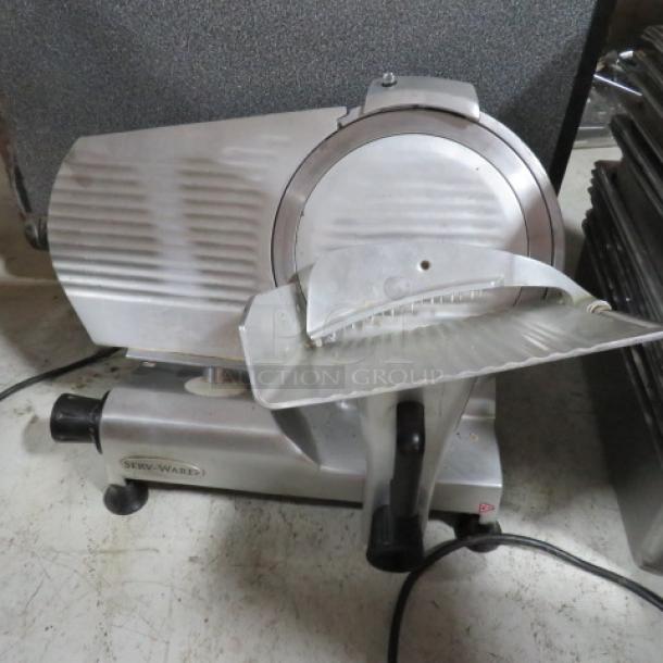 Servware 12-inch deli slicer, Model SLC-12. Features a stainless steel blade, 110V. Appears in good condition.