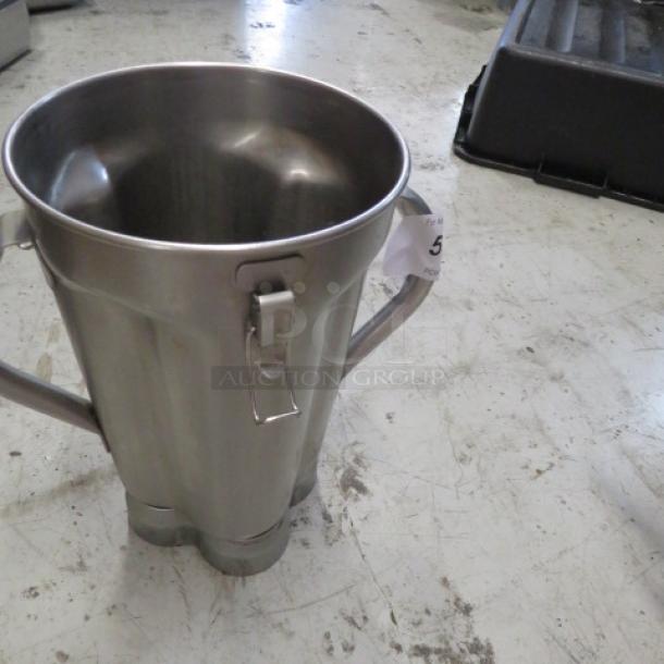 Waring heavy-duty blender pitcher, stainless steel, no lid. Used condition with minor wear. Auction tag visible.