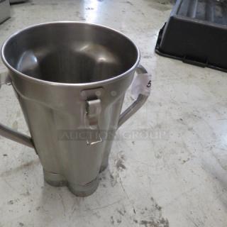 Waring heavy-duty blender pitcher, stainless steel, no lid. Used condition with minor wear. Auction tag visible.