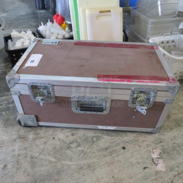 Viking equipment case with metal edges, handles, and latches; shows signs of wear.