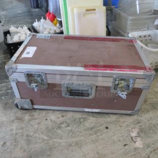 Viking equipment case with metal edges, handles, and latches; shows signs of wear.