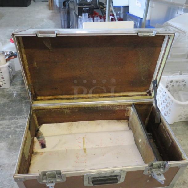 Viking equipment case, open lid, wooden interior with metal hinges, signs of wear, sturdy metal latches.