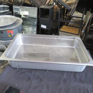 Full size 4-inch deep stainless steel hotel pan in used condition, with minor surface marks. Ideal for catering use.