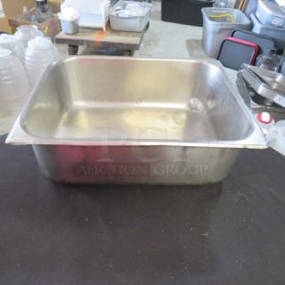 1/2 size, 4-inch deep hotel pan, stainless steel, used condition, minor scratches, versatile for kitchen needs.