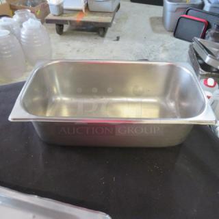 Stainless steel 1/3 size, 4-inch deep hotel pan. Used condition, suitable for catering or food service. Markings indicate 5XBID.