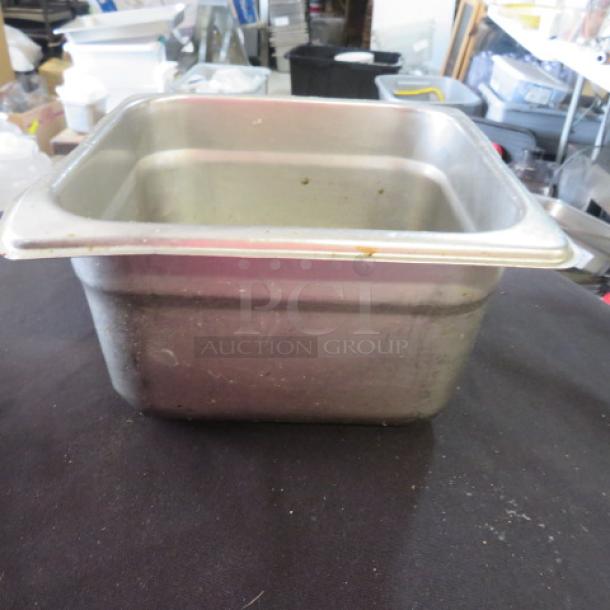 1/6 size, 4-inch deep hotel pan, stainless steel, used condition with minor wear, suitable for food service.