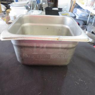 1/6 size, 4-inch deep hotel pan, stainless steel, used condition with minor wear, suitable for food service.