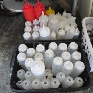 Assorted squeeze bottles in various sizes, colors, and styles. Includes white, red, yellow bottles; mostly plastic. Used condition.