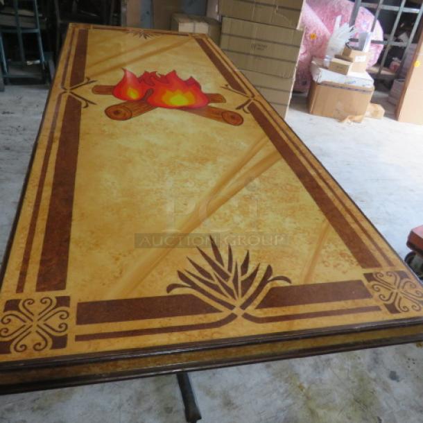 Custom wooden laminated table top on dual pedestal base, 84x36x30 inches. Features ornate design with fire motif, excellent condition.