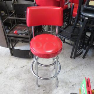 Chrome bar height chair with red swivel cushioned seat and back. Features two chrome rings. Good condition.