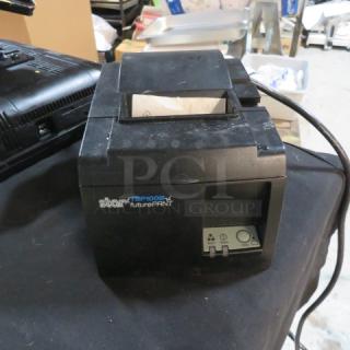 Star TSP100 thermal printer, black, in good condition. Features control panel and visible branding. Model: TSP100.
