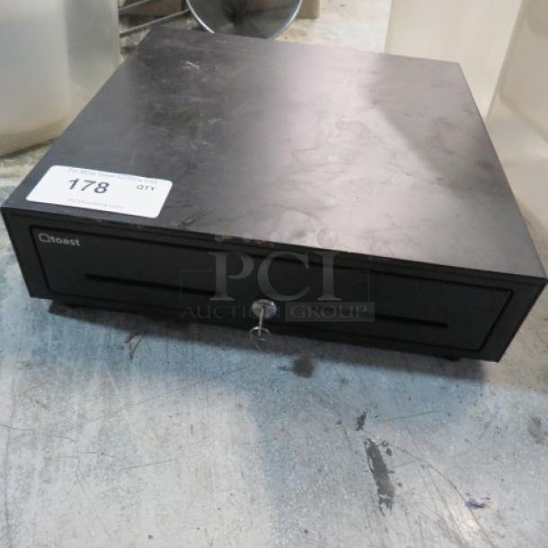Black Toast cash drawer with key, identifier label "178", in used condition.