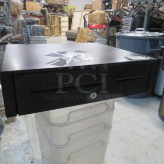 Black cash drawer with key, used condition, slight surface wear, metal construction, secure lock system, ideal for retail.
