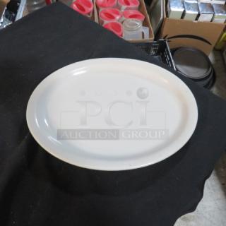 White oval platter, 13x10 inches, smooth finish, excellent condition, displayed on a black surface.