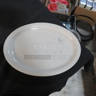 White oval platter, 13.5x10.5 inches, in excellent condition. Smooth finish, suitable for serving.