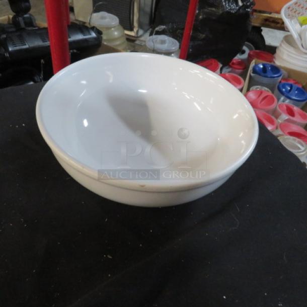 White 9-inch bowl, gently used, smooth finish, no visible markings or labels, ideal for home or kitchen use.