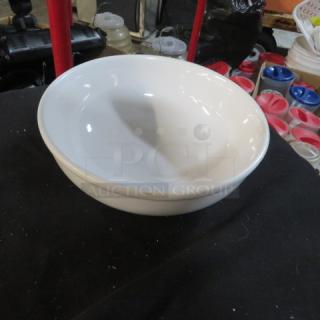 White 9-inch bowl, gently used, smooth finish, no visible markings or labels, ideal for home or kitchen use.