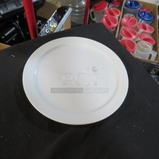 White 10.5-inch plate in good condition on display. Smooth surface, likely ceramic. No visible markings or labels.