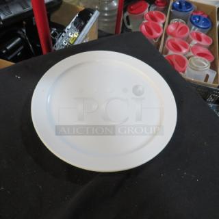 White 10.5-inch plate in good condition on display. Smooth surface, likely ceramic. No visible markings or labels.