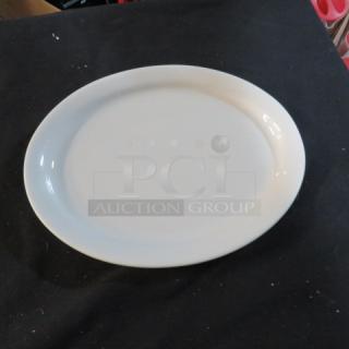 White ceramic platter, 9.5x7.5 inches, in excellent condition. Minimalist design, suitable for serving or display.