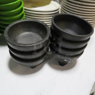 Stacked black salsa bowls, model 7XBID, textured finish, new condition, set among different colored plates.