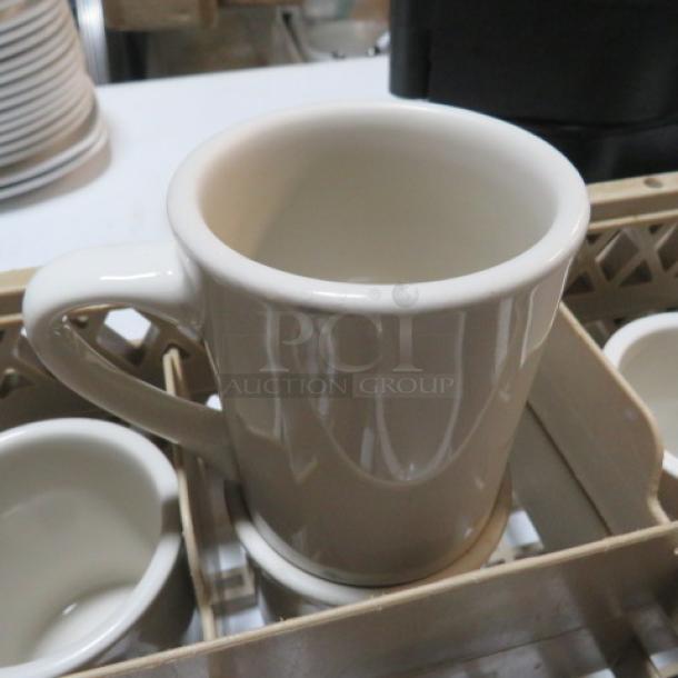 Dishwasher rack with 8 cream ceramic coffee mugs, excellent condition, organized securely in compartments.
