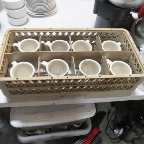 Dishwasher rack with eight white coffee mugs, each in individual compartments. Rack is beige with open lattice design.