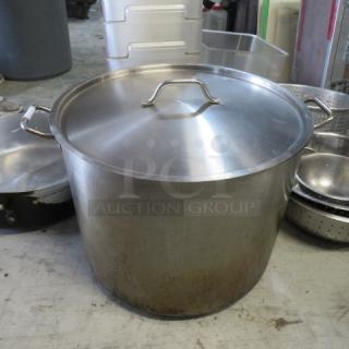 XL stainless steel heavy-duty stock pot with lid, used condition. Features large handles for easy lifting. Ideal for commercial use.