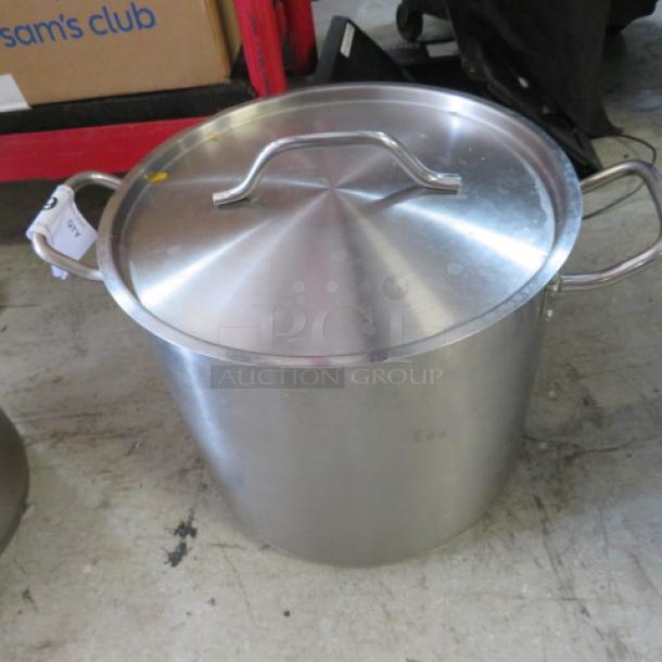 16 quart stainless steel stock pot with lid, featuring sturdy handles and a polished finish. Slightly used condition.