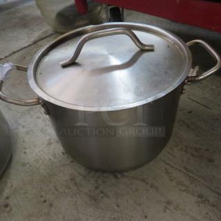 8-quart stainless steel stock pot with lid, featuring sturdy handles. Good condition, suitable for cooking large meals.